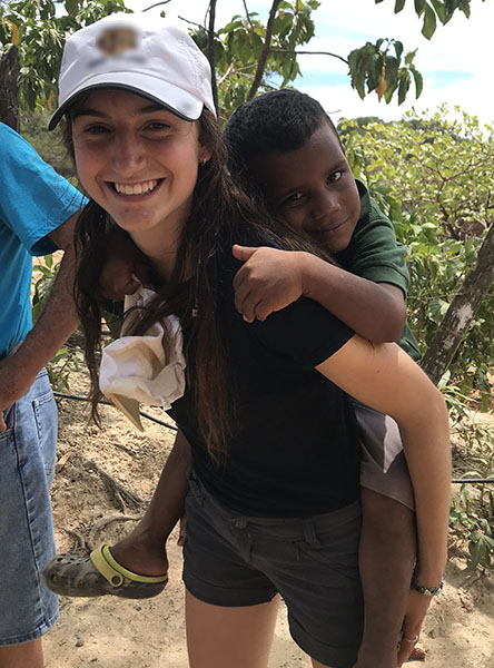 volunteer with young Roatan resident